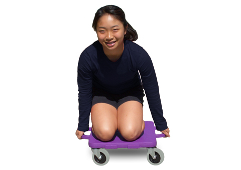 young girl riding a connect-a-scooter gym scooter, on her knees