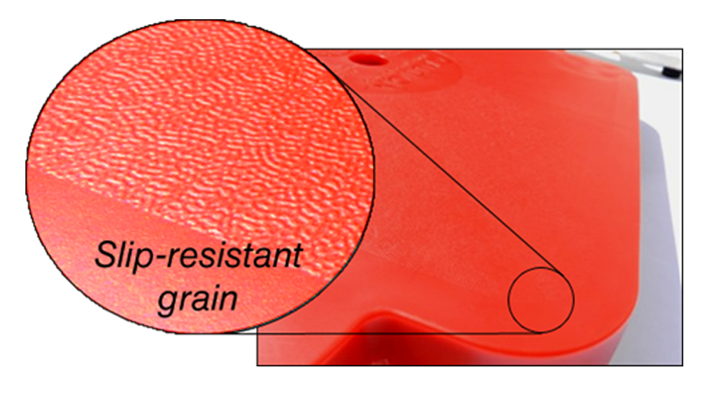 close up of the slip resistant grain molded into the surface of a red connect-a-scooter gym scooter