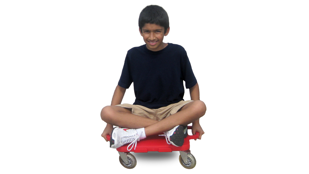 Boy sitting cross legged on a red turbo gym scooter